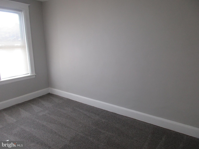 empty room with dark carpet