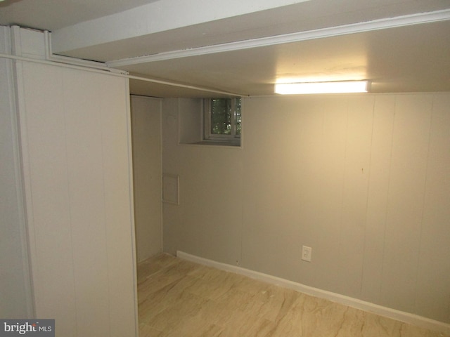 basement with hardwood / wood-style flooring