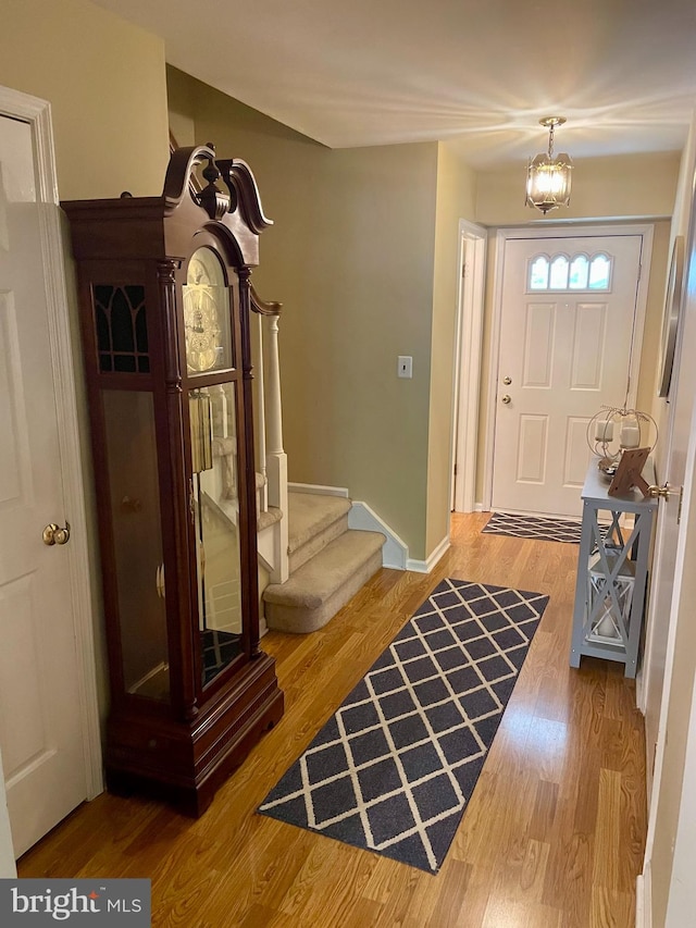 foyer entrance featuring an inviting chandelier and hardwood / wood-style floors