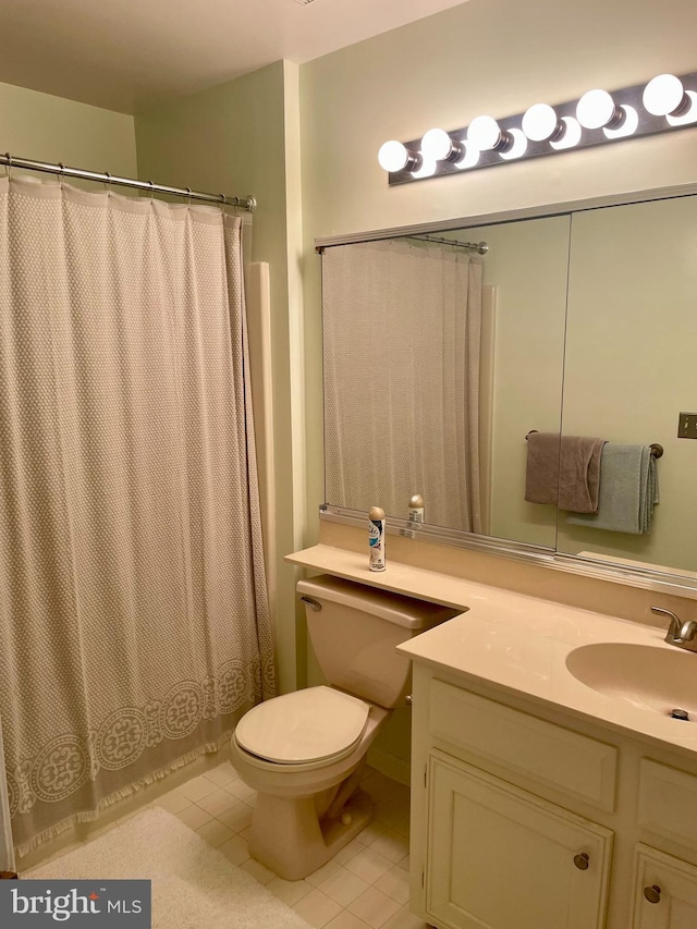 bathroom featuring toilet, curtained shower, vanity, and tile patterned flooring