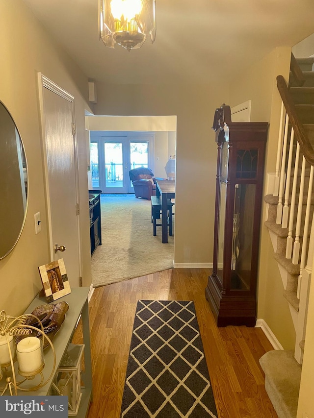 corridor featuring french doors and hardwood / wood-style flooring