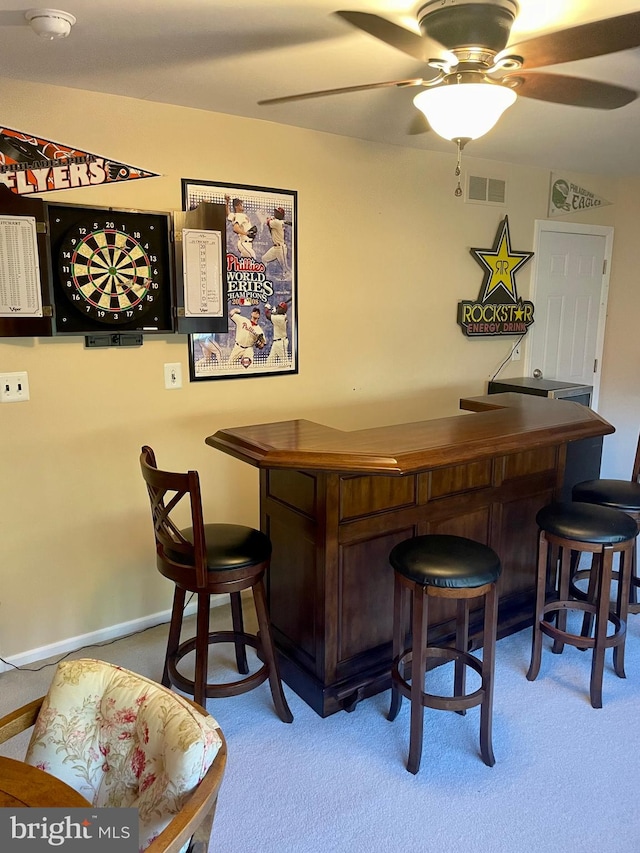 bar with carpet floors and ceiling fan