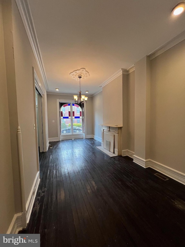 unfurnished living room featuring ornamental molding, baseboards, a chandelier, and dark wood-style floors