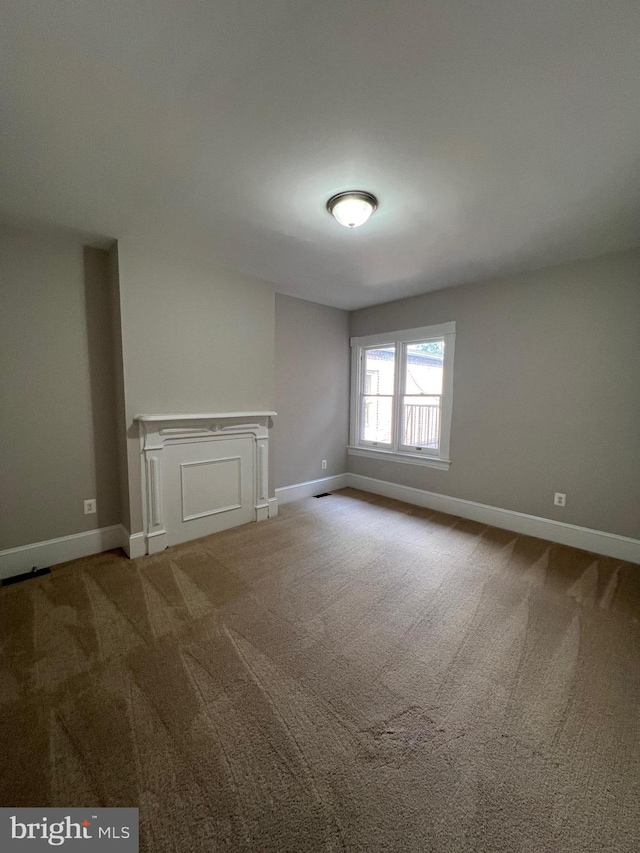 unfurnished living room featuring carpet flooring