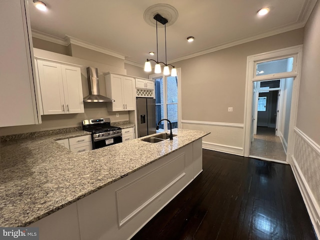 kitchen featuring white cabinets, sink, wall chimney range hood, appliances with stainless steel finishes, and dark hardwood / wood-style flooring