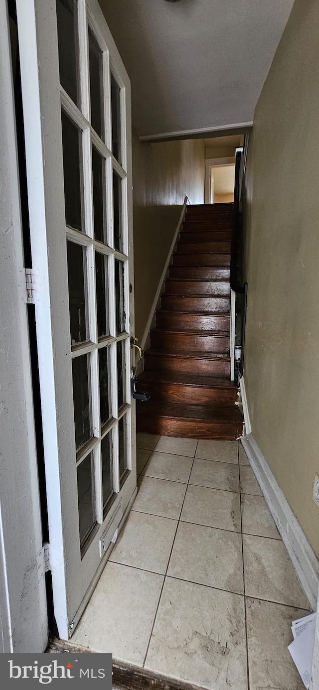 stairs featuring tile patterned floors