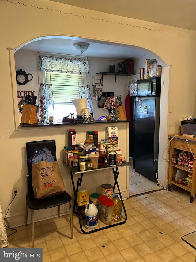 kitchen with black refrigerator