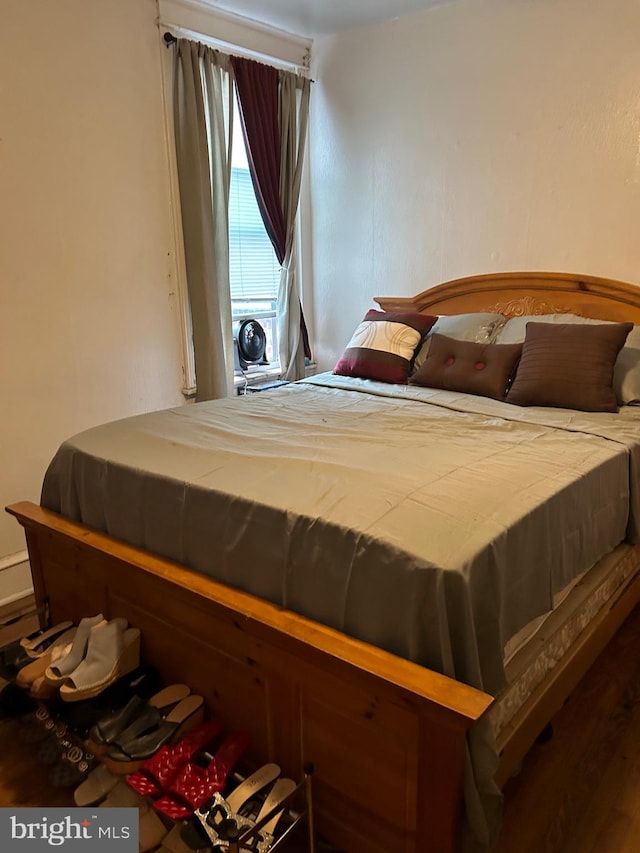 bedroom with hardwood / wood-style floors