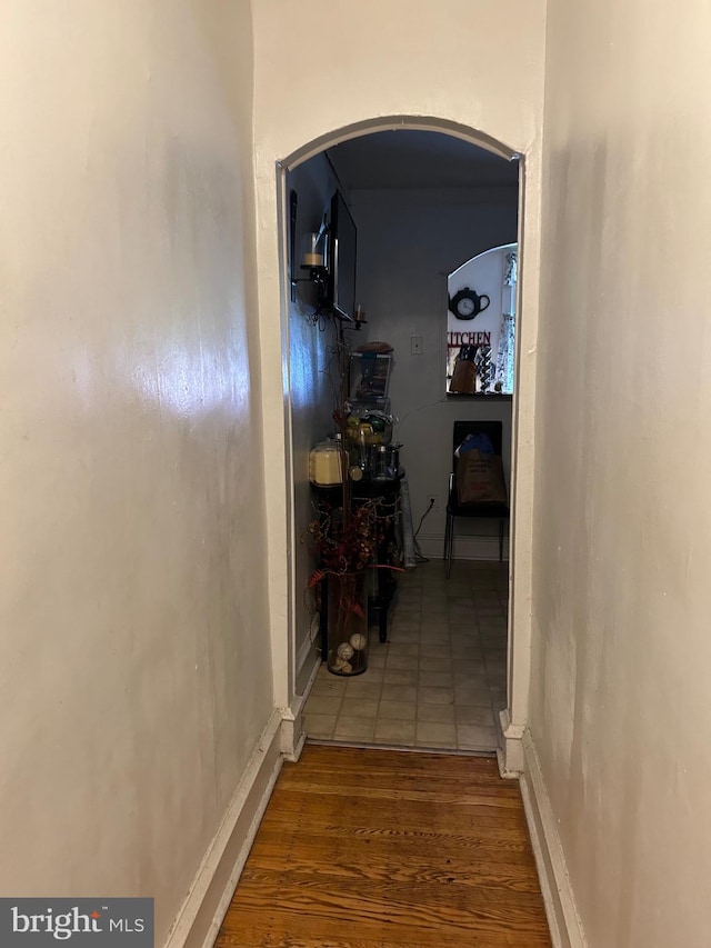 corridor with wood-type flooring