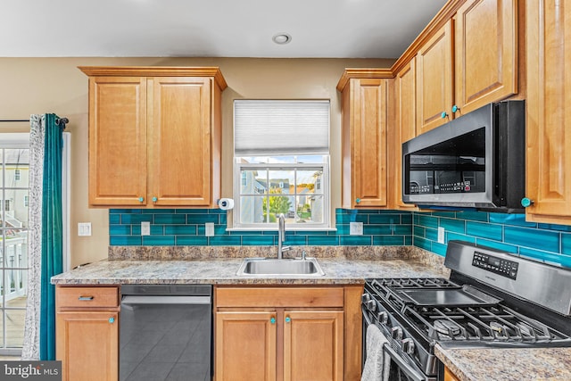 kitchen with sink, stainless steel appliances, and backsplash