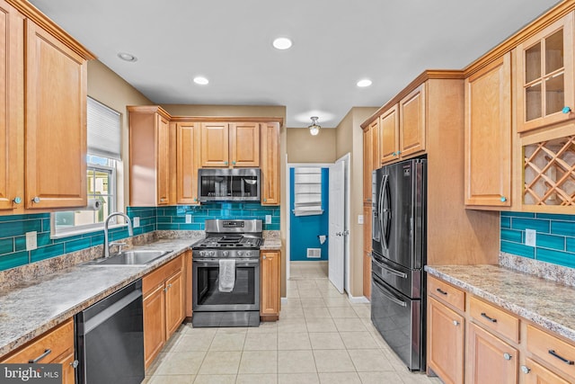 kitchen featuring sink, appliances with stainless steel finishes, and tasteful backsplash