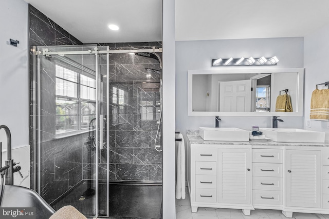 bathroom with a shower with door and vanity