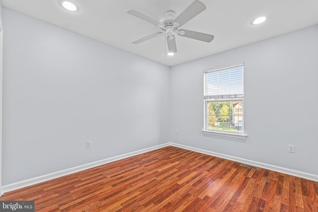 spare room with hardwood / wood-style floors and ceiling fan