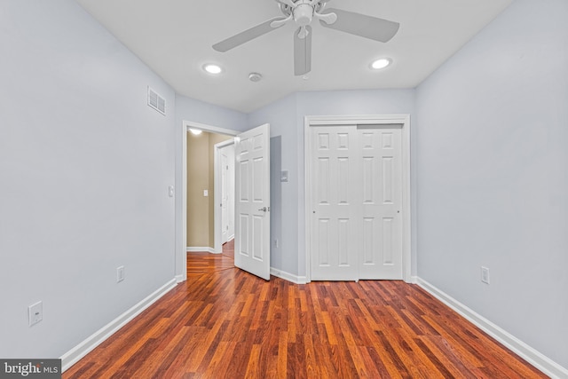 unfurnished bedroom featuring a closet, ceiling fan, and dark hardwood / wood-style floors