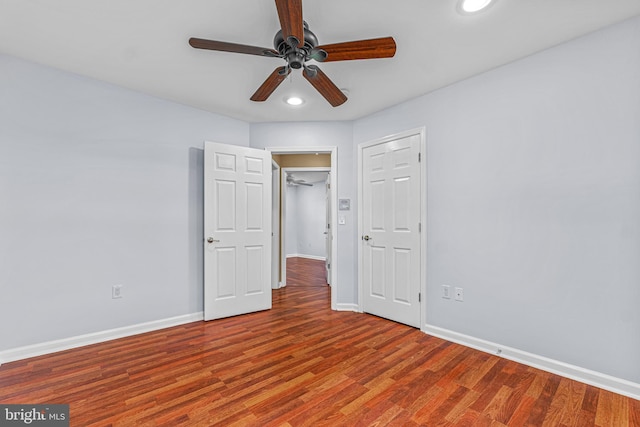 unfurnished bedroom with a closet, ceiling fan, and wood-type flooring