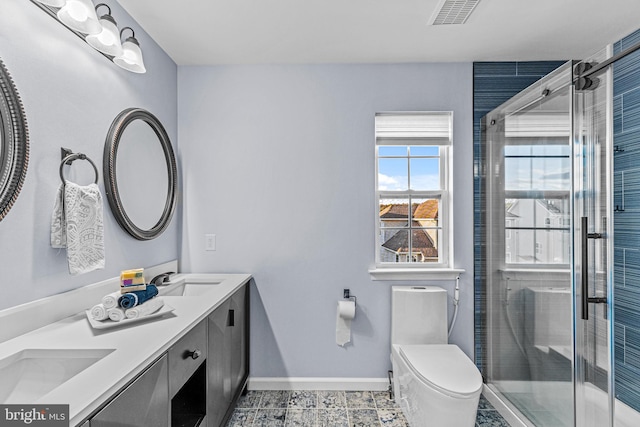 bathroom featuring vanity, tile patterned floors, toilet, and walk in shower