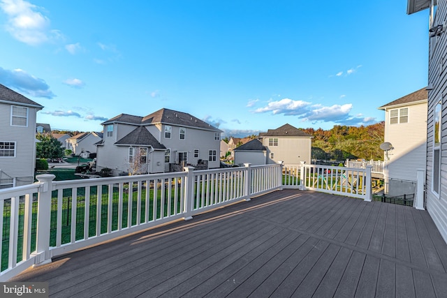 wooden deck with a lawn