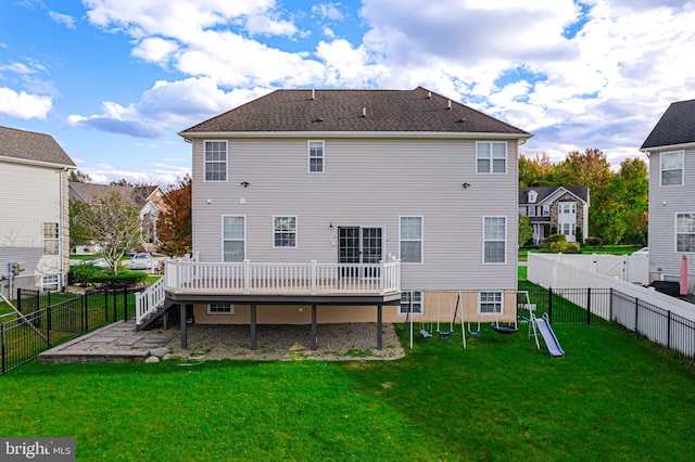 rear view of house with a deck and a lawn