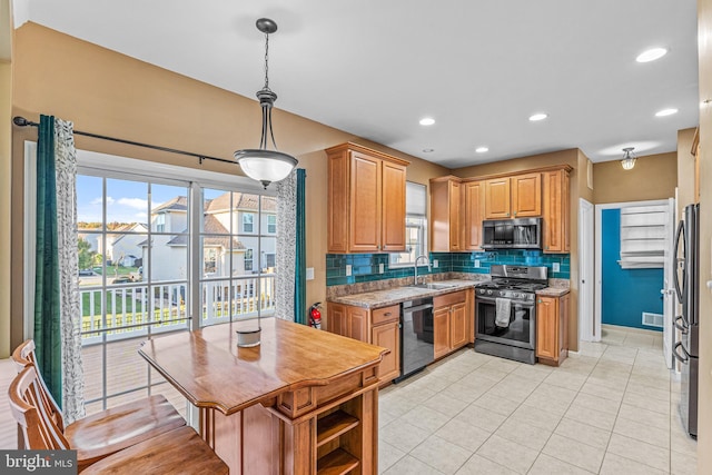 kitchen with tasteful backsplash, hanging light fixtures, light stone counters, light tile patterned flooring, and stainless steel appliances