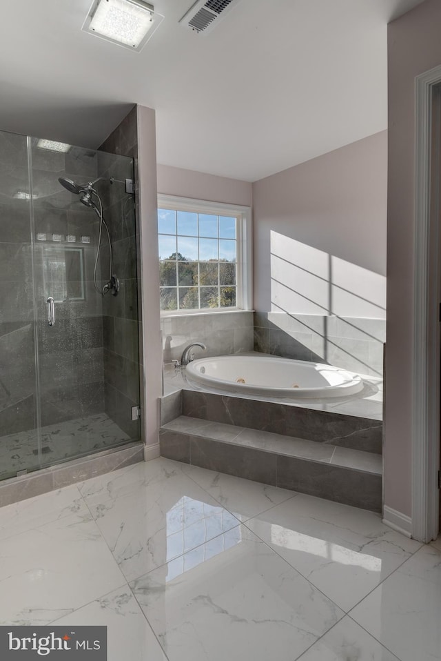 bathroom featuring separate shower and tub