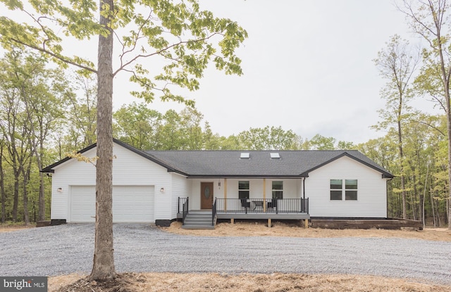 ranch-style home with covered porch and a garage