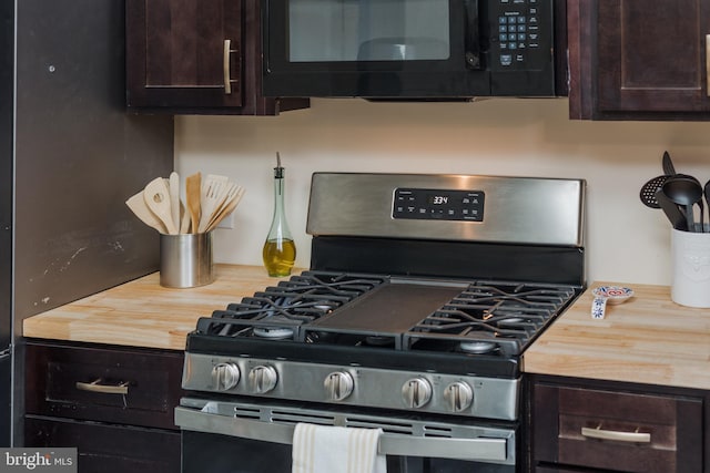 kitchen with stainless steel range with gas stovetop, wooden counters, and dark brown cabinets