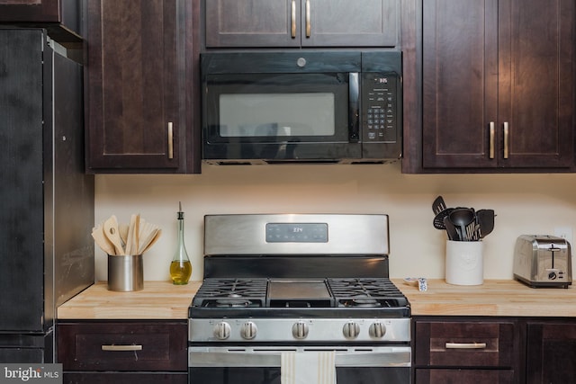 kitchen featuring dark brown cabinets, appliances with stainless steel finishes, and butcher block counters