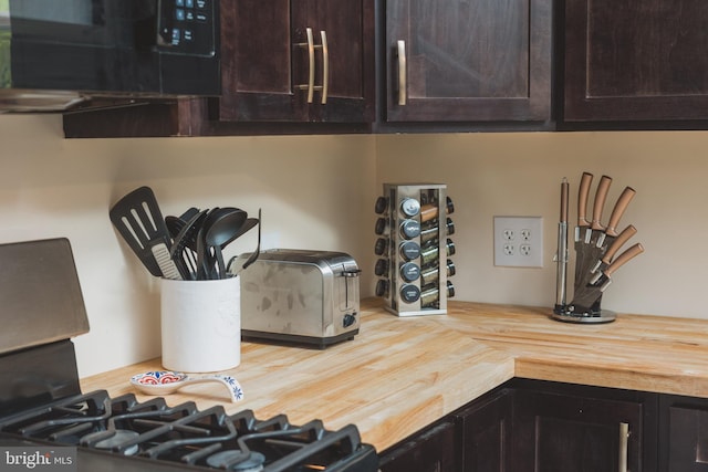 kitchen featuring dark brown cabinetry and butcher block countertops