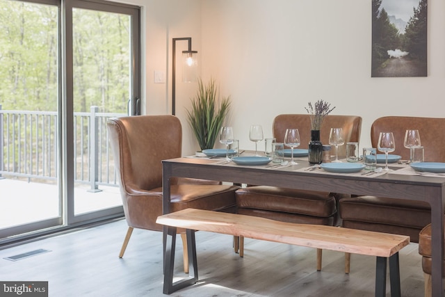 dining space with light hardwood / wood-style flooring