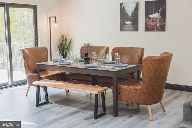 dining space with light hardwood / wood-style flooring