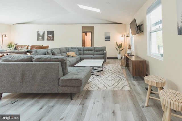 living room with lofted ceiling and light hardwood / wood-style flooring