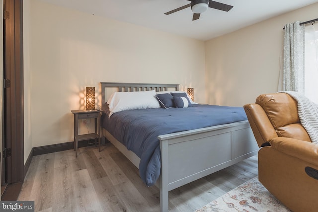 bedroom with ceiling fan and hardwood / wood-style flooring