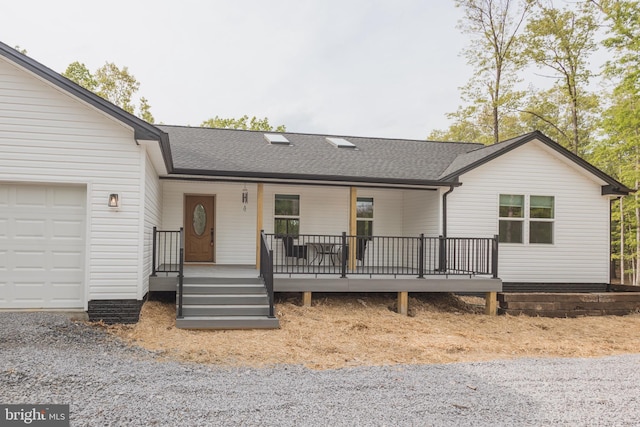 ranch-style home featuring a garage and covered porch