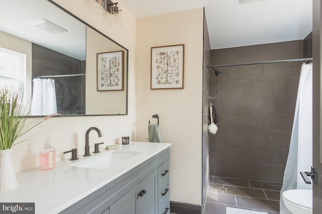 bathroom with walk in shower, vanity, and toilet