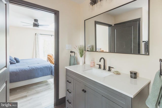 bathroom featuring ceiling fan, vanity, and hardwood / wood-style floors