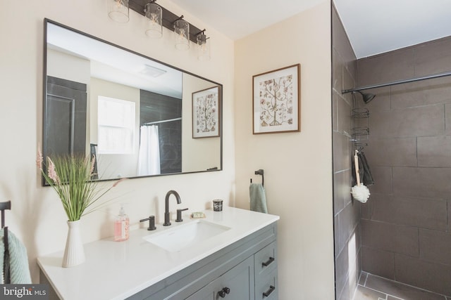 bathroom featuring tile patterned flooring, vanity, and a shower with curtain