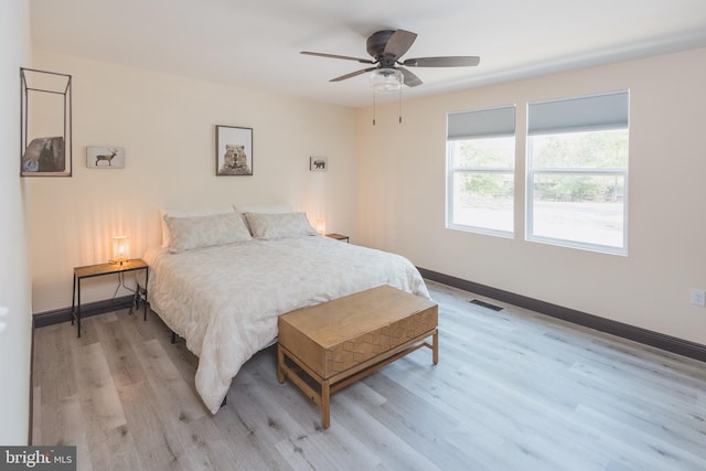 bedroom with light wood-type flooring and ceiling fan