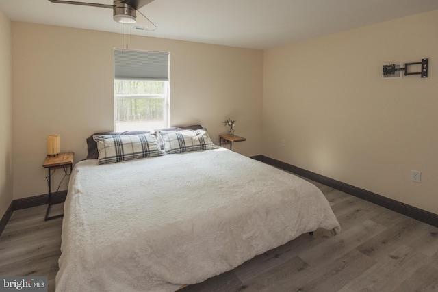 bedroom featuring ceiling fan and dark hardwood / wood-style flooring