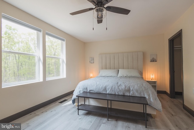 bedroom with light hardwood / wood-style floors and ceiling fan