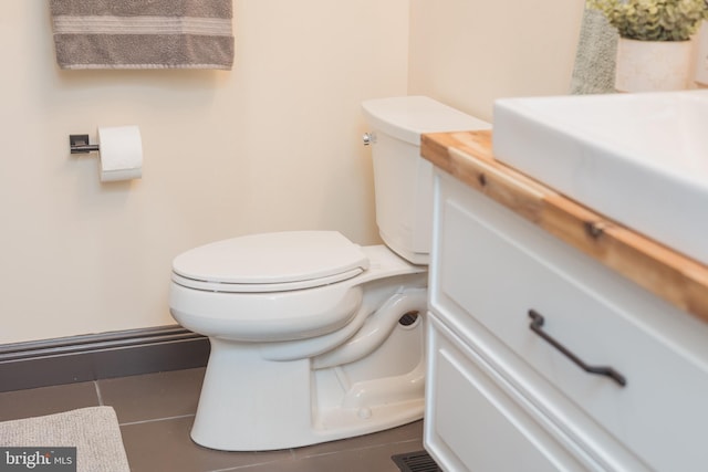 bathroom with tile patterned floors, vanity, and toilet