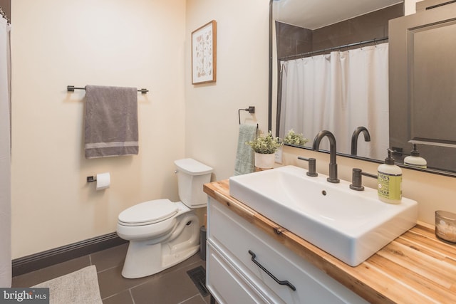 bathroom featuring vanity, toilet, and tile patterned floors