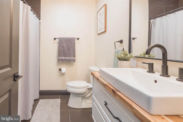 bathroom with tile patterned flooring, toilet, and vanity