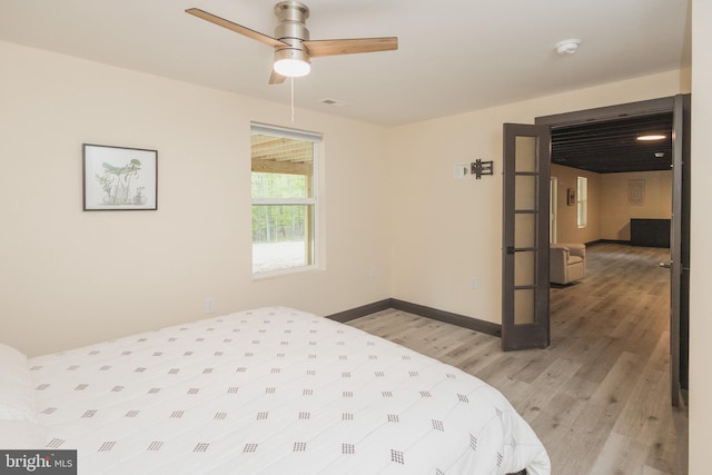 bedroom featuring light hardwood / wood-style floors and ceiling fan