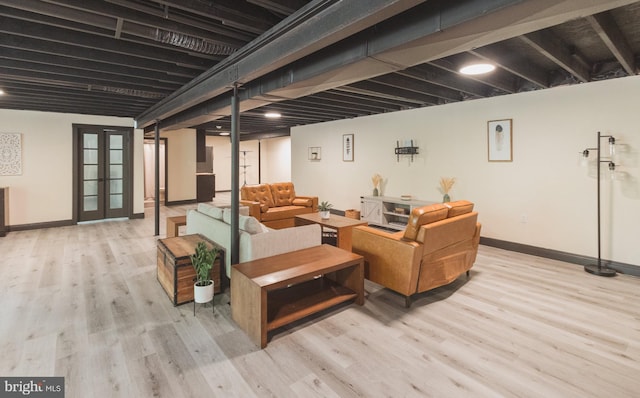 basement with light hardwood / wood-style flooring