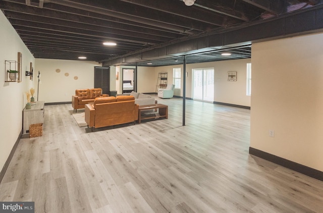 basement with light hardwood / wood-style flooring