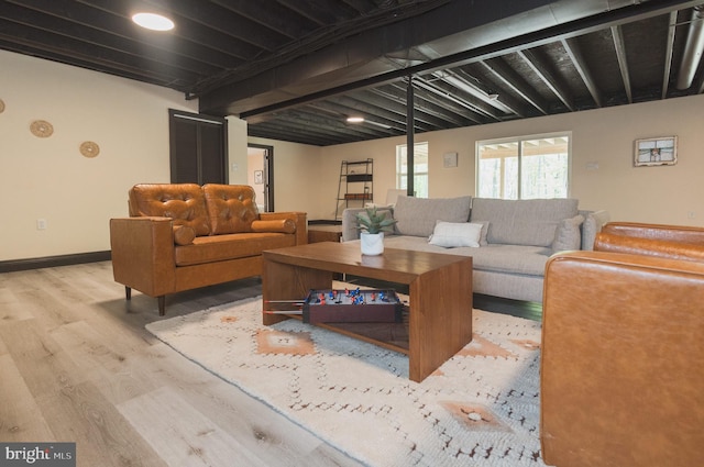 living room featuring light hardwood / wood-style floors and beam ceiling