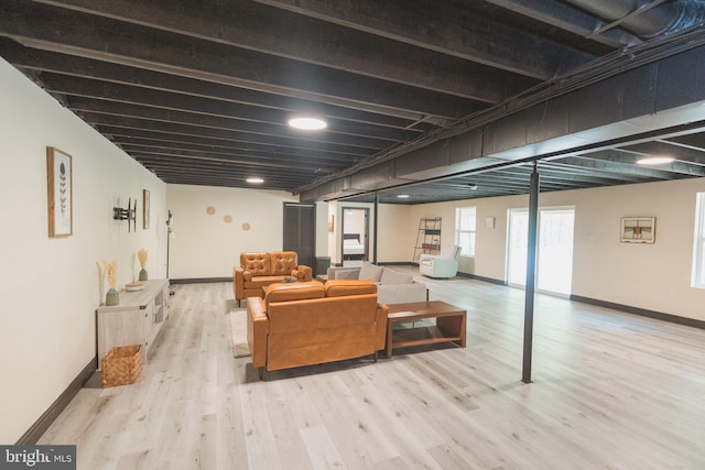 basement with light hardwood / wood-style floors