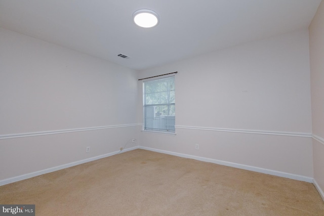 spare room with light colored carpet