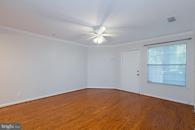 spare room with ornamental molding, ceiling fan, and wood-type flooring