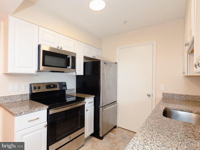 kitchen featuring light stone countertops, white cabinets, and appliances with stainless steel finishes